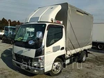 фото Грузовик бортовой тентованный MITSUBISHI CANTER кузов FE70D год вып 2010 грузоподъемность 3 тн пробег 63 т.км